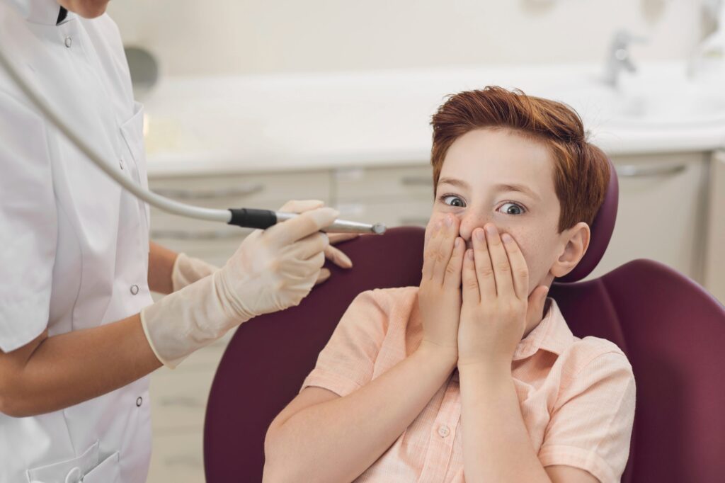 The child is afraid to have his teeth treated. Dental care and treatment. Children's dentistry. Dentist's office.
