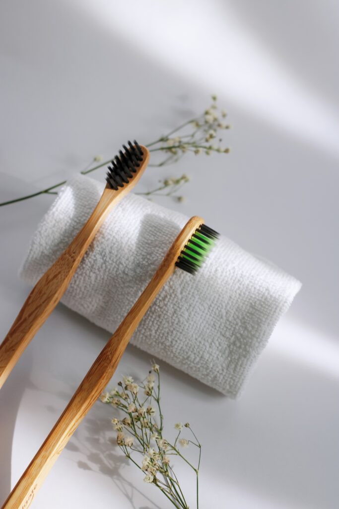 Two toothbrushes on a white towel